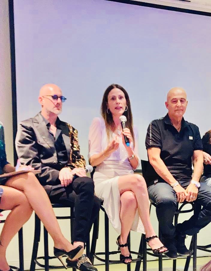 ד״ר ערגה אטד עם מיקרופון בפאנל מקצועי